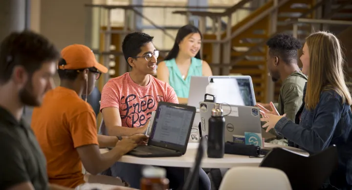 Students on laptops in library