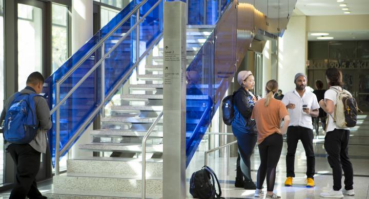 Students chatting in building lobby